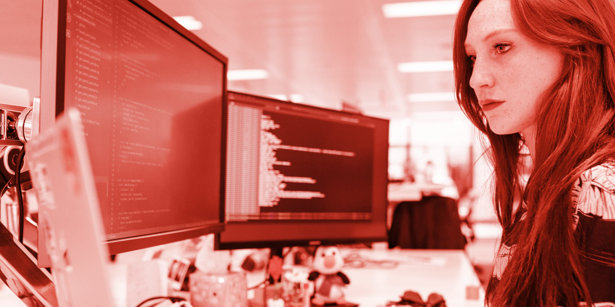 Tech contractor coding on a computer