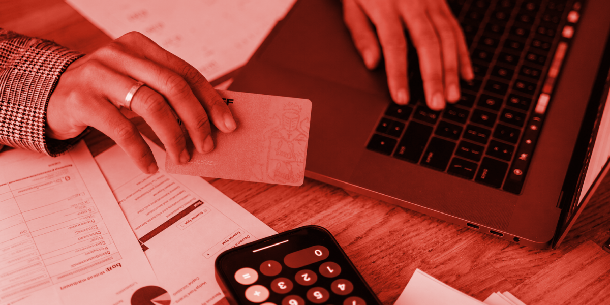 Looking at bank statements, image has a red brand tone overlay