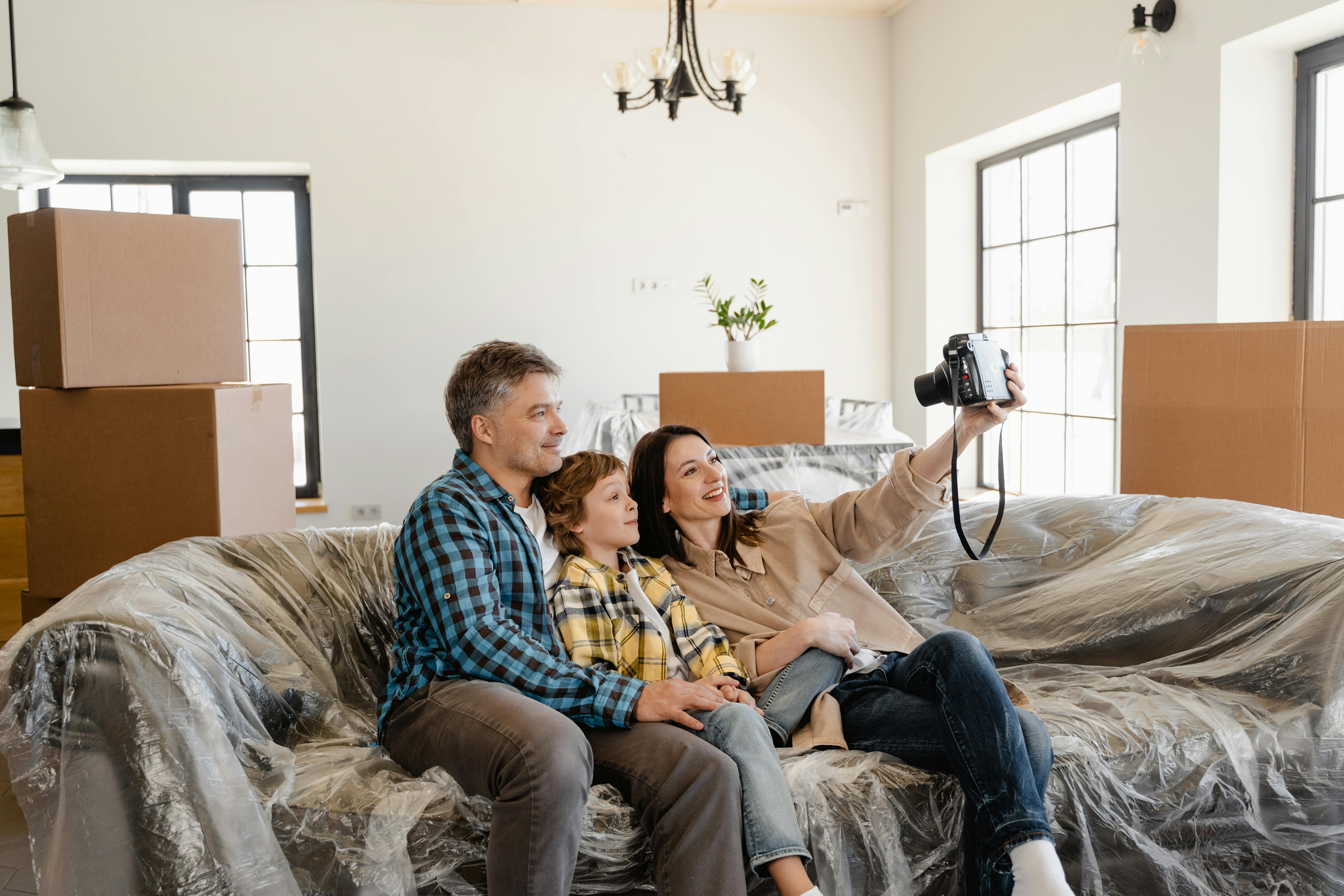Family of 3 on the couch taking a selfie